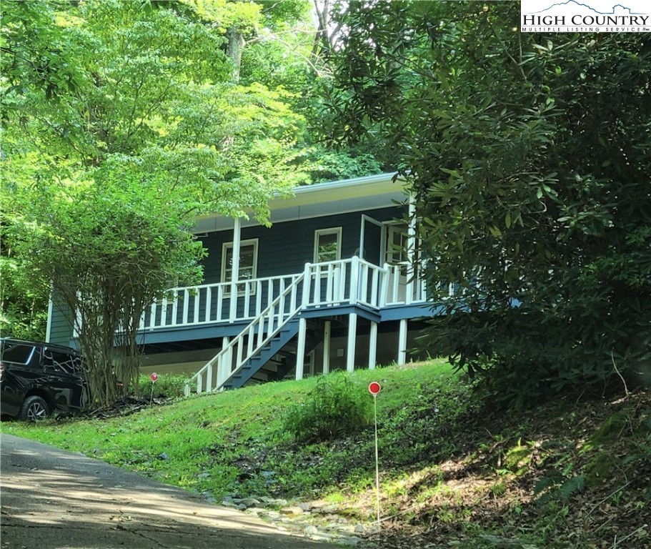 Lovely cottage style home in the heart of Boone, so near to everything but you'll feel like you're away from it all at the end of the day. Enjoy the large rocking chair porch or morning coffee on the back deck surrounded by forest and rhododendrons. Beautiful stone fireplaces - 1 up and 1 down - let you know you're living in the mountains! Two En Suite bedrooms on the main floor plus a full bath and an additional room downstairs which could be additional sleeping area, playroom, entertainment/game room. Off of this room, there is an additional room which could be a home office, study or hobby room. Pull into your 1 car garage and stay warm and dry in inclement weather! Minutes to Shopping, Restaurants, Hospital, Samaritans Purse and all NC High Country activities, this home's location can't be beat! Folks, this entire home has been upgraded over the past few months to include floor to ceiling interior paint, new insulation, all new flooring, new fixtures, etc.  All that's left is the kitchen awaiting your personal touch.  Ready to move in today! *** 1/16/2022 Multiple Offers Received ***