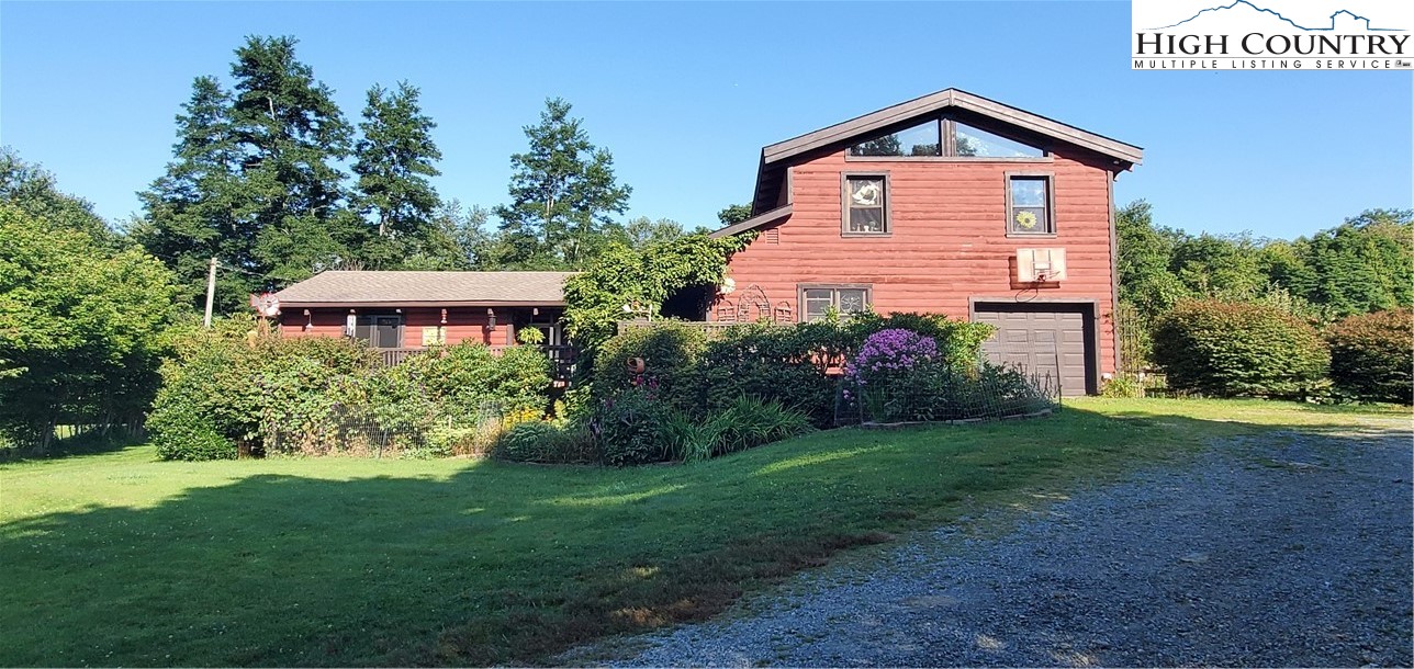 This charming home sits on almost three acres of prime land (which is very hard to find in this area), offers long range mountain views with gorgeous sunrises, just off the Blue Ridge Pkwy in a most desirable Green Hill Rd location, and within 4 miles of Hwy 321 in Blowing Rock and Blowing Rock Golf Course.  This parcel of land has two outbuildings for storage as well.  Inside, the living area with eat-in kitchen is very spacious and offers a wood stove for additional warmth and ambiance. Off the kitchen is a sunroom for relaxing. The spacious master bedroom offers a walk-in closet and ensuite bath complete with whirlpool tub and shower. On the opposite side of the house are two more bedrooms that share a hall bath, and a sitting/bonus room with double doors that lead out to the front porch and deck where you can enjoy long-range mountain views. Upstairs over the garage is a large bonus room with over 700 square feet of space for whatever use you wish. Make an appt to see this rare find today.  With it's convenient location, additional land for garden, horses or possible additional building spots, it's sure not to last long!