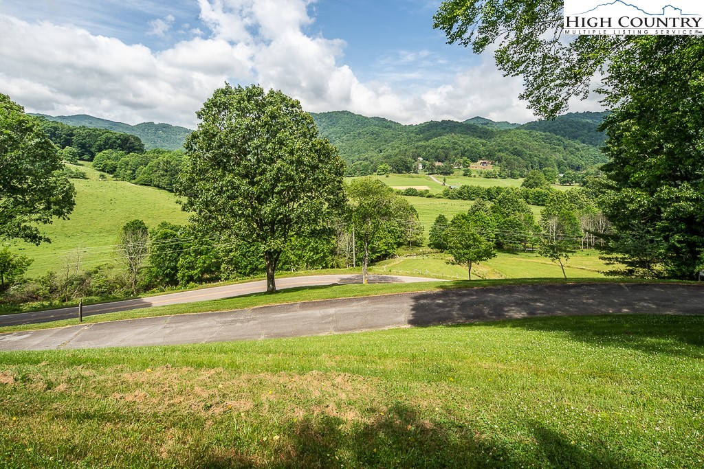 Million Dollar views in the valley from this lovely home in the Valle Crucis Historical District. The historic district is very restrictive on future development. With Easy access off of Clarks Creek Rd. the paved driveway leads right up to this one level living home. Sit on the front porch and enjoy the peace and quiet that makes you want to stay here. You must come look and fall in love here with this piece of history in the Valley. Wheelchair accessible and one-story living is so hard to find in Valle Crucis so do not miss seeing this one. Don't let the fact that it is was built in 1956 stop you from looking. This home has undergone extensive renovations. Such as 50-year shingles, on demand hot water, pex plumbing, Granite, nicely updated kitchen, with the double oven and gas range just to name a few. 2.55 acres backs up to the Priscah National Forest. Large front and rear deck to enjoy the morning or evening sun. The massive 24x32 foot great room has a massive stone fireplace all to make entertaining great. Please come and visit today. Short and long-term rentals are allowed here. Unbranded tour link available