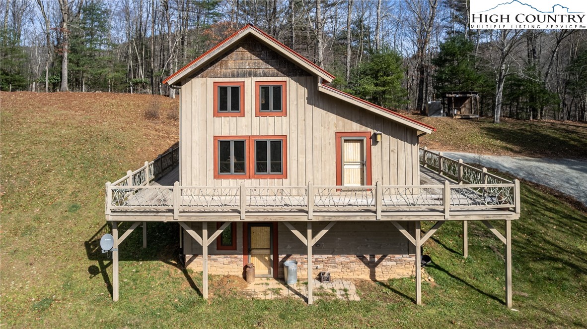 A custom-built cabin on almost 5 unrestricted acres, w/ intentions of living "off the grid."  The "best of both worlds," can be had. Grid or not, the property is located approximately 15 minutes from West Jefferson and 20 minutes to Boone. The custom features include the following: Timber frame w/ structural panels on the walls and roof. Two fireplaces w/ 1 in the GR and 1 in the MBR. Outdoor wood boiler with zoned hydronic heat in the cabin, w/ gas back-up heat. All Energy Star appliances. Gas stove, gas dryer, and gas water heater. There is a 2500 watt solar system partially installed. There are 7 more panels at the house to install and then batteries added in order to go off of the grid.  The owner is a contractor; however, the cabin still needs some completion: the upstairs loft needs to have permanent flooring installed, and railing installed around the area looking down into the GR. They will give a flooring allowance w/ an acceptable offer. There is a separate entrance to the basement, but it has space under the staircase that can lead to the basement. There are several outside buildings for storage and equipment. This is an opportunity to put your own style into the cabin.