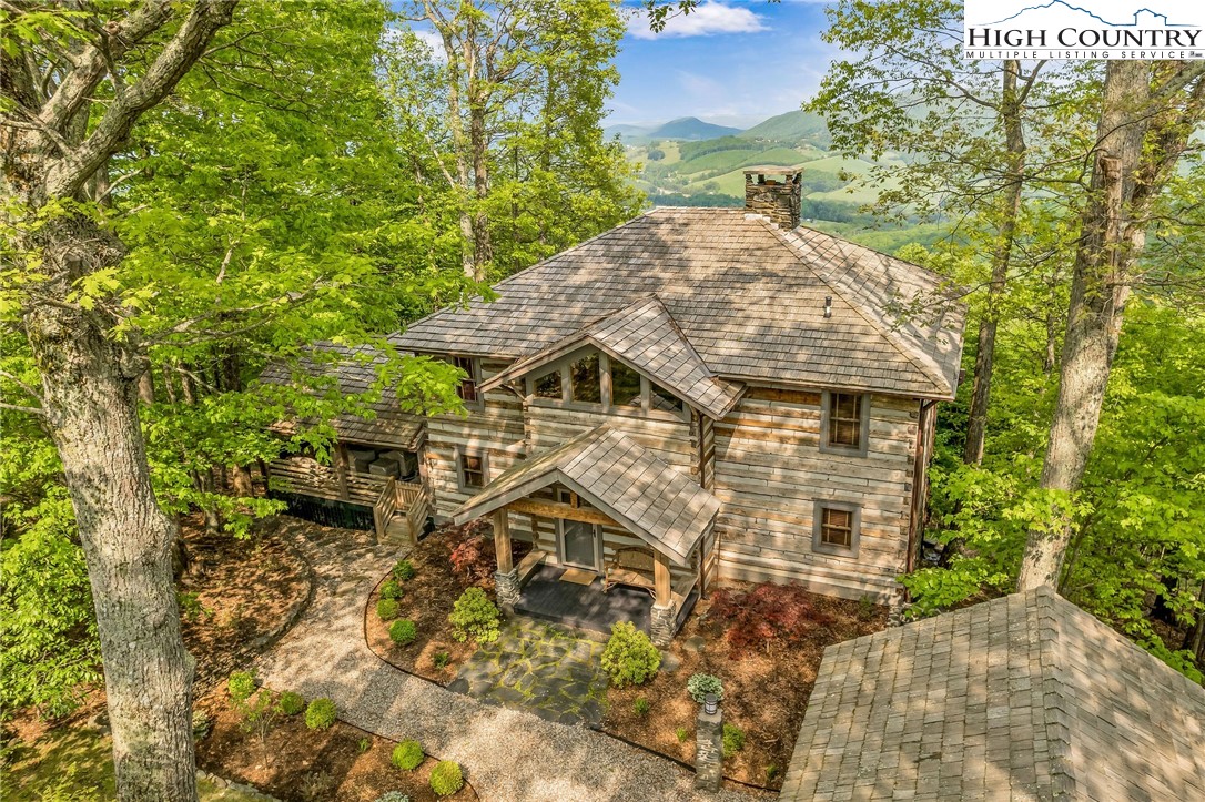 CLASSIC STONEBRIDGE CONSTRUCTION WITH UNIQUE ARCHITECTURAL DESIGN - Enjoy your morning coffee on east-facing decks w/ a breathtaking long-range view including colorful sunrises. Inside, a vaulted ceiling, wall of windows & a wood-burning fireplace nestled within a soaring stone chimney flanked by four dramatic stone columns creates a rustic, yet elegant, space to savor the view & your time in the Blue Ridge Mountains. Main level also provides spacious & open kitchen/dining area which leads to a lg covered deck featuring an impressive outdoor fireplace, pantry/laundry combination, powder room and sizable master suite with 3rd stone fireplace. Upper level provides plenty of space for family & friends w/ bedroom, 2 bonus rooms, 2 baths and sitting area with 4th stone fireplace. Lower level provides family room w/ 5th fireplace (gas logs), wet bar & plenty of storage space. For low maintenance, you will appreciate the new Pella windows & doors, Trex decking & fiber cement board on the backside of the cabin. This MOUNTAIN MASTERPIECE is being sold FURNISHED w/ a collection of antiques from Europe & across the US, including numerous hand knotted Persian rugs & Teak outdoor furniture.