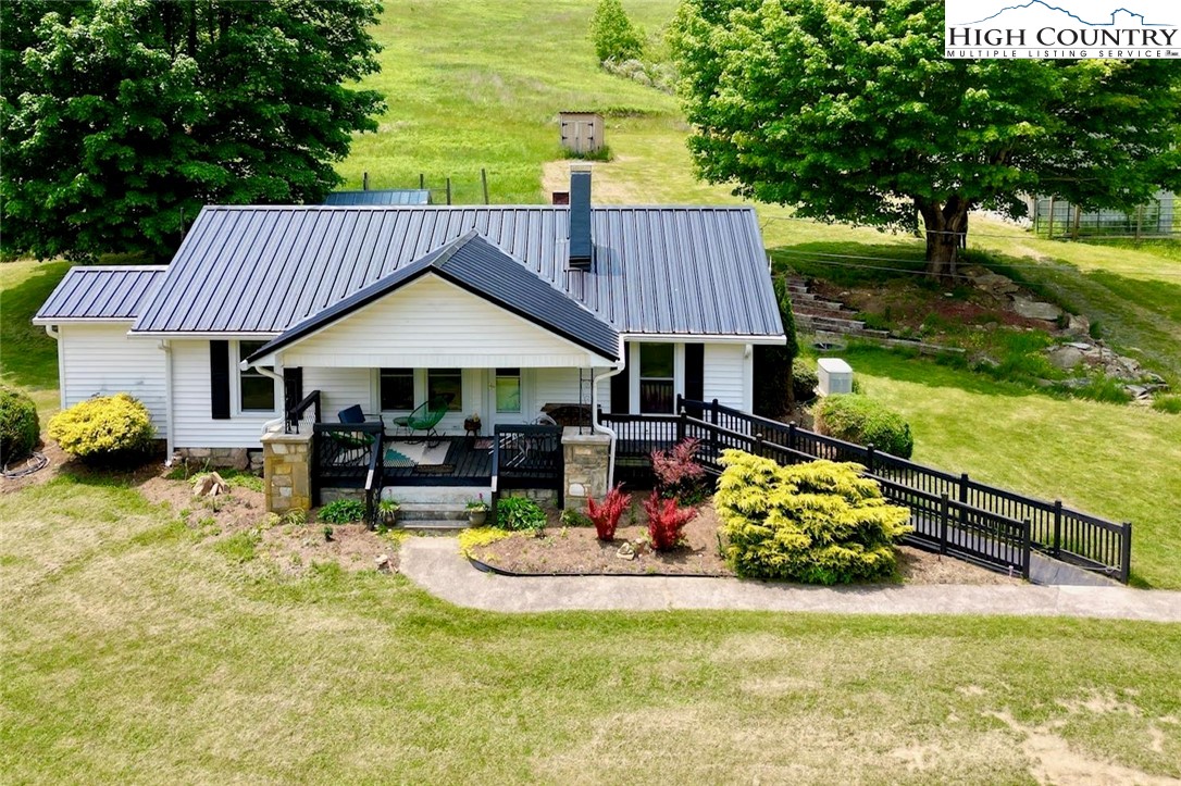 Rare gem in the NC High Country... restored 1930’s farmhouse w/ 22 ac of gentle sloping pasture land well suited for a horse farm or mini-farm, old growth forest, breathtaking massive boulders in the upper corner of the property & amazing serene & long-range mountain views. This beautiful home is located in an upscale neighborhood in the Sugar Grove / Cove Creek area. Desirable one level living home, 3 BR/ 1 BA, living area w/ gas FP, dining RM, Kit, & laundry area/mud RM. Experience the lovely features including: original wood walls & recently refinished original cherry HW floors, granite countertops in Kit & updated BA w/ walk-in tiled shower, relaxing covered front porch w/ handicap ramp access, paver patio w/ built-in fire pit for entertaining w/ friends, metal gated entrance, generator & 4 Mitsubishi mini splits. Multiple outbuildings include: original tobacco barn, chicken coop, a second barn w/ stalls, 2 additional building w/ great potential or storage, detached one-car garage w/ carport & well house. Three sources of water: well, stream in front of home & natural spring w/ spring box. Centrally located to Boone, Valle Crucis, ski slopes & other popular attractions.