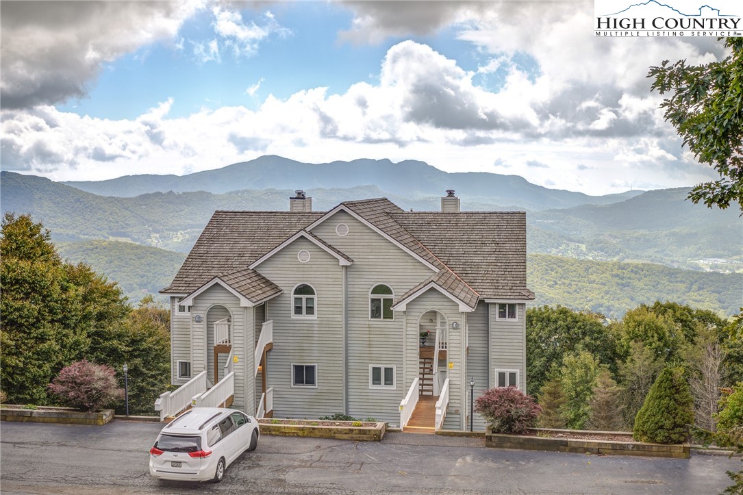 Enjoy spectacular layered mountain views, including Grandfather Mountain, from this updated 2 bedrm/2 bath condo in Beech Mountain. At 5000+ ft elevation, you’ll appreciate cool summer days on the covered deck, where you can bask in that view! The recently renovated kitchen offers leathered granite counters, stainless steel appliances, undermount sink, tile backsplash and newer flooring. On cool winter evenings, you’ll enjoy gathering around the propane fireplace in the cozy living area, or you can step outside through the glass doors to the covered deck and feel the fresh mountain air...and be amazed by that view! The spacious primary bedroom has a king-sized bed and dresser as well as an updated ensuite bath with tile walk-in shower. A secondary bedroom and full bath provide additional space. Newer stackable washer/dryer in hall closet. All new double paned windows w/transferable warranty. Located just outside the Beech Mountain town limits (so no city taxes), but just minutes to skiing and all the amenities Beech Mountain/Banner Elk have to offer. This condo would be a great short-term rental or a vacation home. Sold furnished with a few exceptions.