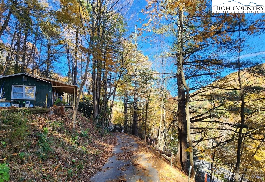 Tiny House just off Hwy 105 in Boone on 4.5 acres! Overlooking the Watauga River across the road. Sweet location is only minutes away from Appalachian State University, Grandfather Mountain & all the ski resorts in Boone, Blowing Rock & Banner Elk! Unique tiny house built in 1961 is 475 sqft and is in the middle of renovations. Currently occupied by a tenant with a lease that conveys. Open Floor plan with large living room that flows into kitchen. Full bath + one small bedroom & 1 small bonus room. Large lot has room for expansion or building additional cabins. Additional 7.75 acres + another tiny house is available next door for a total of 12.25 acres & 2 small houses.