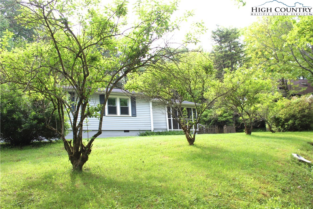 This small cottage is only a 10-minute drive to Blowing Rock and only 5 minutes to the Blue Ridge Parkway! The home is nestled on 1.39 acres just off of 221. The entrance to the home has a large covered screened-in porch. The home has 2 bedrooms and 1 and ½ baths. The ½ bath is off the primary bedroom. The garage and other additions were done by the previous owner, no permits have been found. The home is being sold as-is, it needs some TLC but has limitless possibilities for the right buyer.