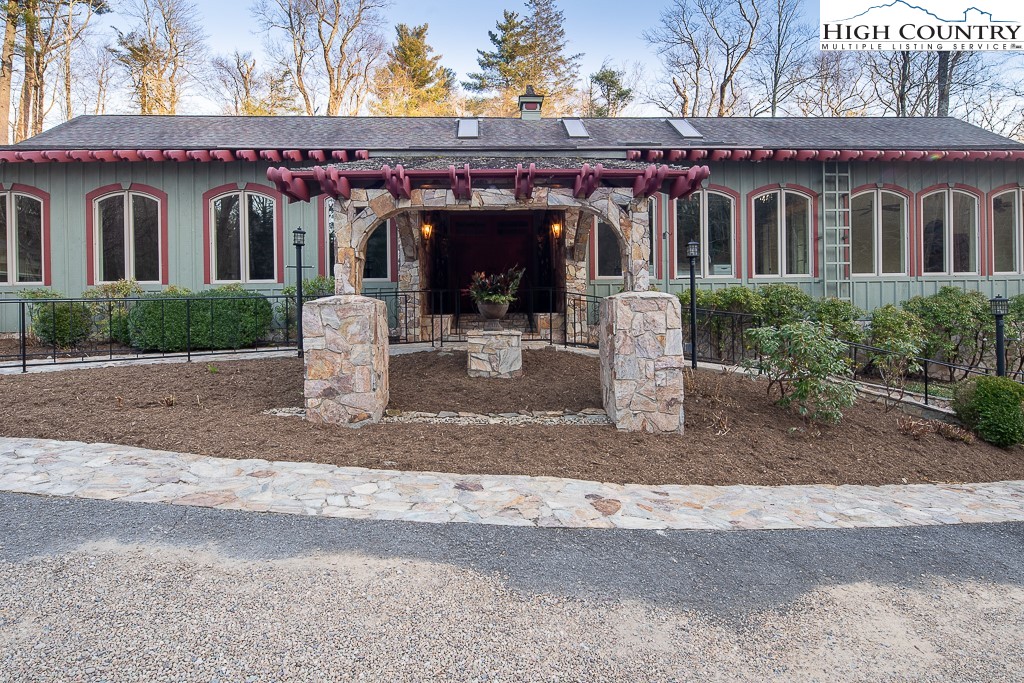 Enter a private gate to a prestigious estate surrounded by natural woodlands on 1.5 acres. 5,281 square feet of living space! The main manor house was designed by a world traveler in 2007.Upon opening the front door is a large, centralized living room w/cathedral ceiling, exposed beams, & impressive, antique alabaster chandelier. Gorgeous hardwood flooring. Surrounded by windows, the sunroom leads to an impressive solarium w/everything for the creative gardener: oversized sink, misters, & much more. Customized throughout, the house contains many antique treasures shipped back from around the world & incorporated into the interior design. Connected to the property via a heated, stone walkway, is a covered, stone outside party area, including a pizza oven, grille, & fireplace. From the stone patio, continue to the side entrance of the 8-car garage.  Above garage is the second residence, which is a lovely apartment with two bedrooms, 2 baths..ideal for family and/or friends. Also on the estate is an Asian-inspired pagoda overlooking a stream, giving the homeowner a sense of serenity/relaxation. Close to Blowing Rock Country Club, an oasis of beauty in the heart of Blowing Rock.