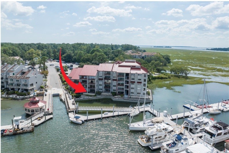 This 1 BR Palmetto Bay Club villa is a standout property. It offers the largest 1 BR floor plan in the complex making it truly spacious & comfortable. It is set apart with the inclusion of a side window, a unique feature that lends feeling of an end unit, giving more natural light, a sense of openness + additional water view. With handscraped hickory wood flooring, quartz counters & subway tile, just bring your furnishings. Enjoy panoramic views of the marina & Broad Creek. Enjoy the Island lifestyle with restaurants next door * water sports in your backyard. Complex is pet friendly for owners & offers fitness room & community storage room.