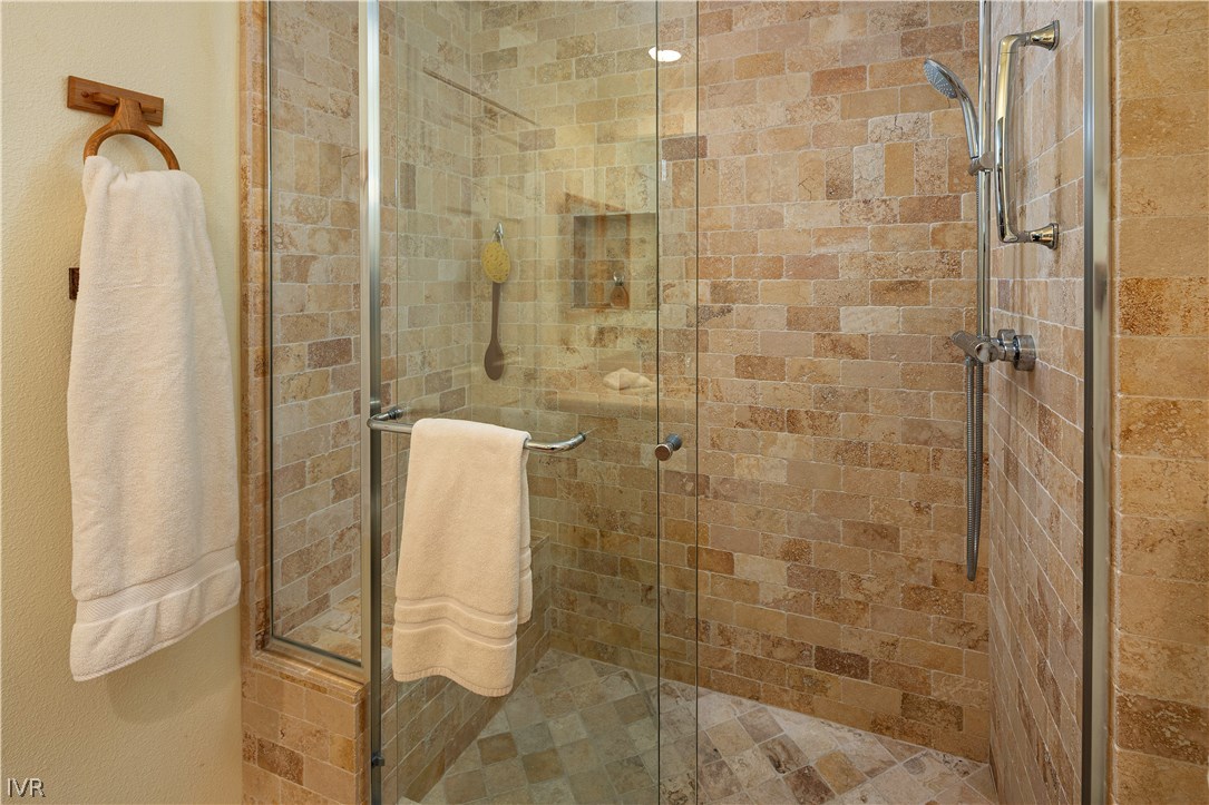 Photo #21: Spacious master shower features solid glass doors