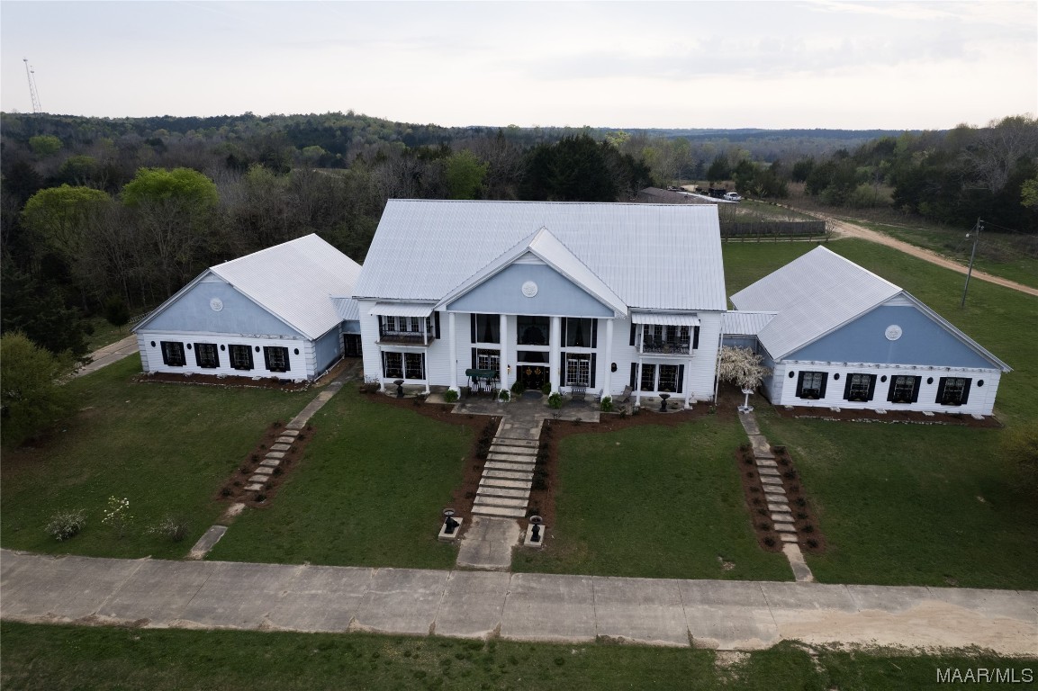 It’s been called the “Mansion on 80” as it sits on 51+ acres of serene country property just 10 minutes from the Montgomery Airport. The 17,000-square-foot home has been used for weddings, class reunions, birthday celebrations, anniversary parties, and a personal home. Built by sellers in 2002, there are so many individualist details and uniqueness, it is impossible to list them here in this small space, so we have prepared a detailed brochure with many more pictures that can be forwarded to you. There is a beautiful home with room galore and a huge pond loaded with catfish and two large koi fish. You’ll enjoy watching the ducks and geese enjoy the water. Seven Peacocks stroll the property. Deer have been seen many times----in fact, the seller offers the opportunity to purchase extra acreage in the back side of the property for nature enjoyment. The garage holds eight vehicles and has a large storage room attached. A main suite with kitchen and separate sitting room on the main floor, and a 1500 square foot ballroom with 27 crystal chandeliers and two half baths. The kitchen has all appliances, including a wine fridge and a large sitting area with a half bath—walk-in pantry from the kitchen. The dining room seats 12+ easily (a description of this room alone would take several paragraphs). As the dual staircase leads upstairs from the foyer, you will arrive at the great landing overlooking the entrance. Find a main suite with approximately 1500 square feet, private baths, and many more extra amenities at each end. You must see this unbelievable home and setting to appreciate its uniqueness and value. Call me or your favorite REALTOR for a copy of the Brochure that describes at length this ONE-OF-A-KIND PROPERTY!