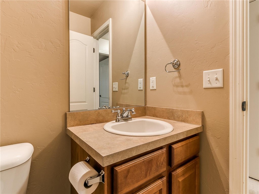 8605 SW 45th Terrace, Oklahoma City, OK 73179 half bath with mirror, toilet, and vanity