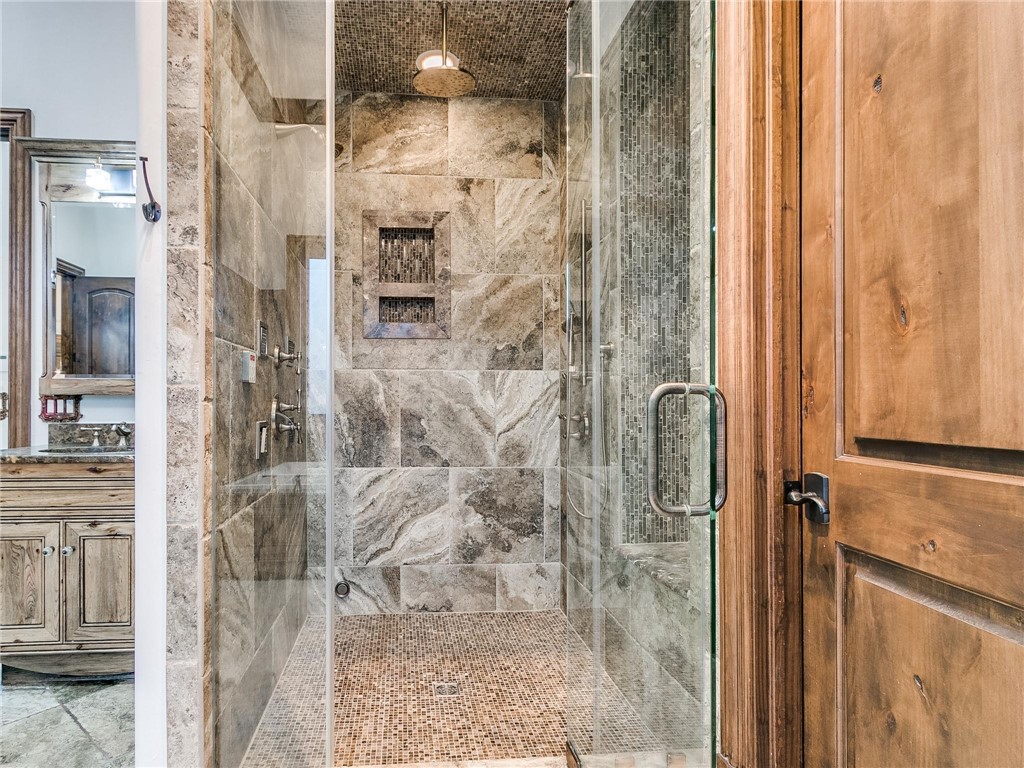 11649 Mill Hollow Court, Oklahoma City, OK 73131 bathroom featuring shower with glass door