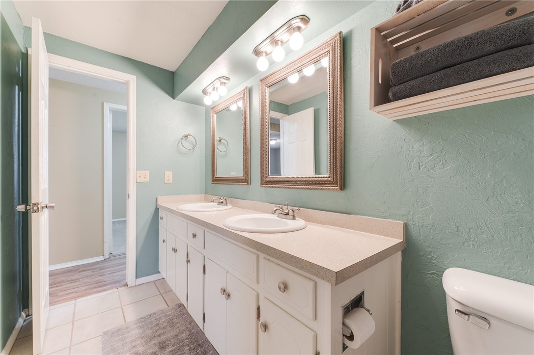 3712 N Markwell Avenue, Bethany, OK 73008 half bathroom featuring hardwood flooring, toilet, mirror, and double vanity