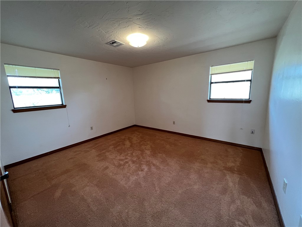 777 NW Chosin Road, Lawton, OK 73507 carpeted spare room with a healthy amount of sunlight
