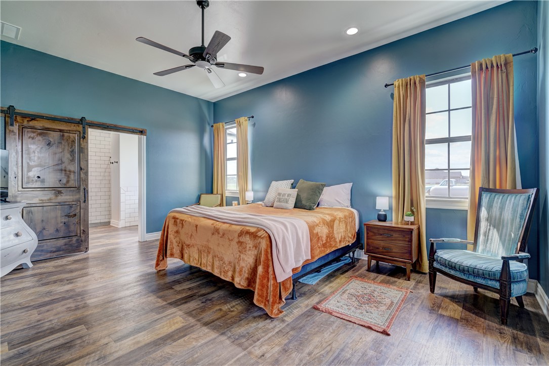 48294 Garretts Lake Road, Shawnee, OK 74804 hardwood floored bedroom featuring a ceiling fan
