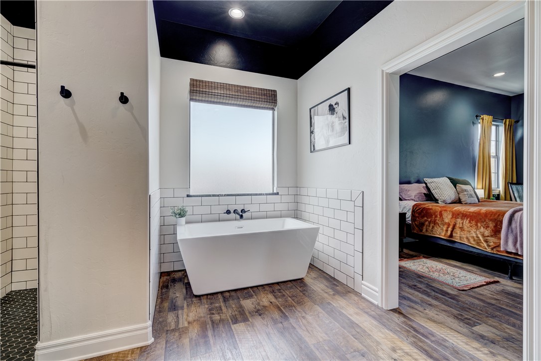 48294 Garretts Lake Road, Shawnee, OK 74804 bathroom with wood-type flooring and a bath