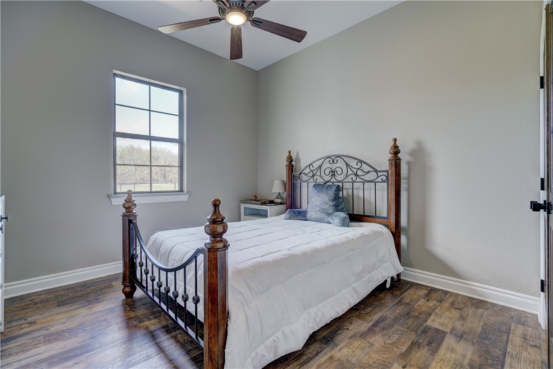 48294 Garretts Lake Road, Shawnee, OK 74804 bedroom featuring hardwood floors, natural light, and a ceiling fan