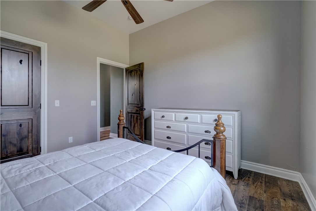 48294 Garretts Lake Road, Shawnee, OK 74804 hardwood floored bedroom featuring a ceiling fan