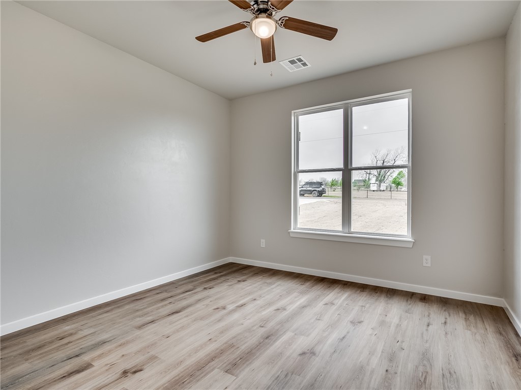 1005 Heritage Hills Drive, Tuttle, OK 73089 hardwood floored spare room with natural light and a ceiling fan