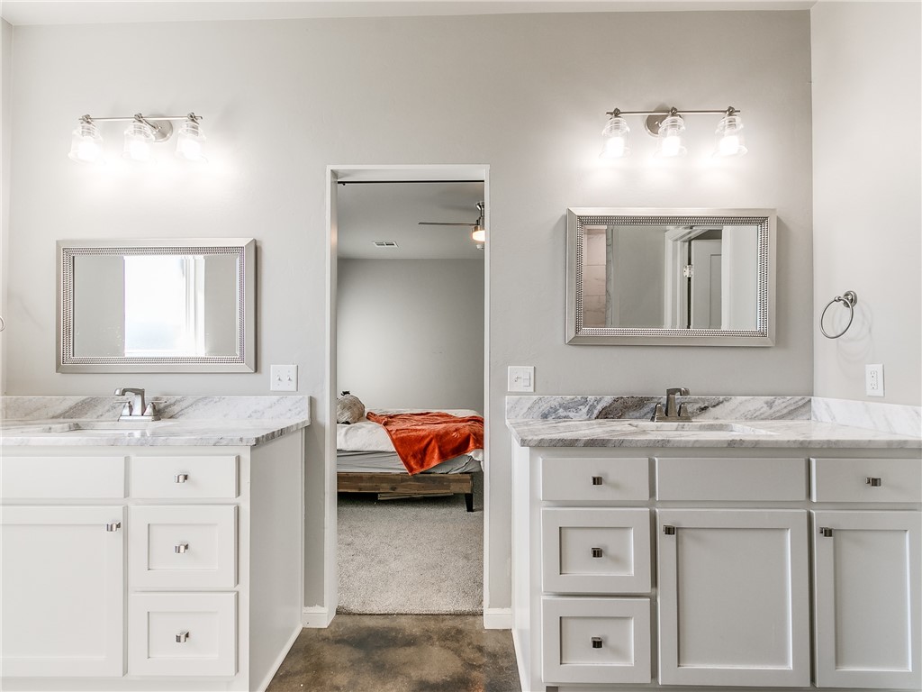13304 Brampton Way, Yukon, OK 73099 bathroom featuring a ceiling fan, dual mirrors, and his and hers vanities