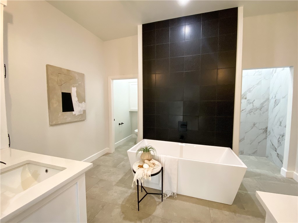 2441 SW 127th Street, Oklahoma City, OK 73170 bathroom featuring tile flooring, vanity, and a washtub