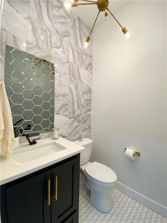 2441 SW 127th Street, Oklahoma City, OK 73170 half bath featuring toilet, mirror, and vanity