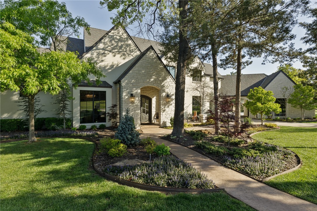 3900 Plum Creek Circle, Oklahoma City, OK 73131 tudor-style house with a front lawn