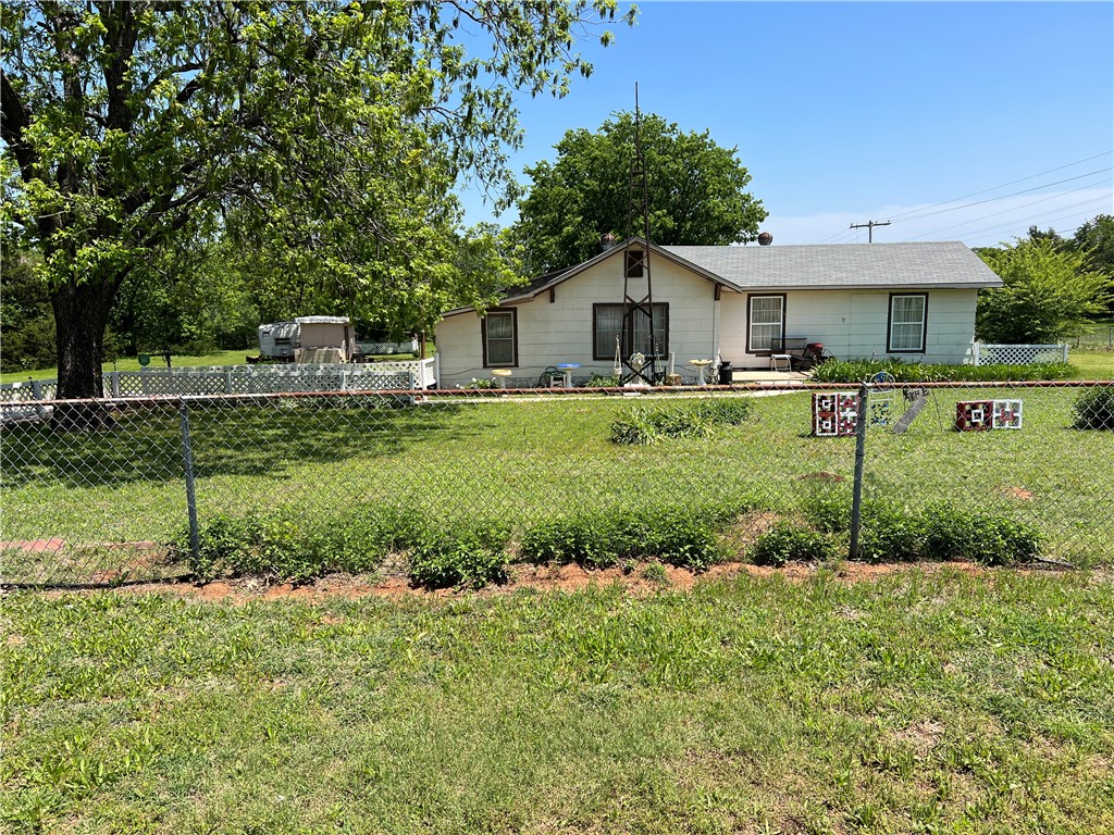 Great corner lot with lush green trees, pecan, etc.  House is livable and great shop with room for 5 cars.  Home and shop need TLC and roofing.  Great place to build your dream home.  Access to Robinson and close to college and shopping.  Location couldn't be any better. Close to I-35!!
