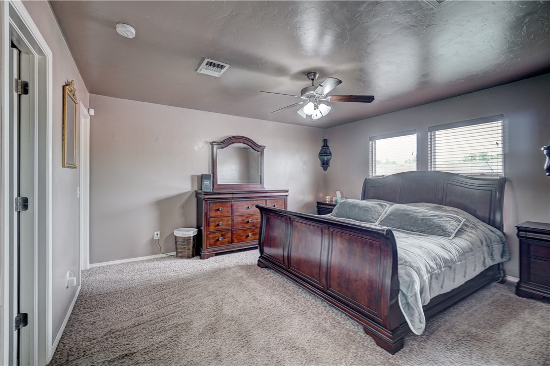 9533 SW 25th Street, Oklahoma City, OK 73128 carpeted bedroom with a ceiling fan and natural light