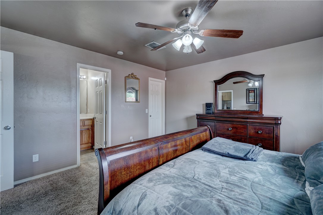 9533 SW 25th Street, Oklahoma City, OK 73128 carpeted bedroom with a ceiling fan