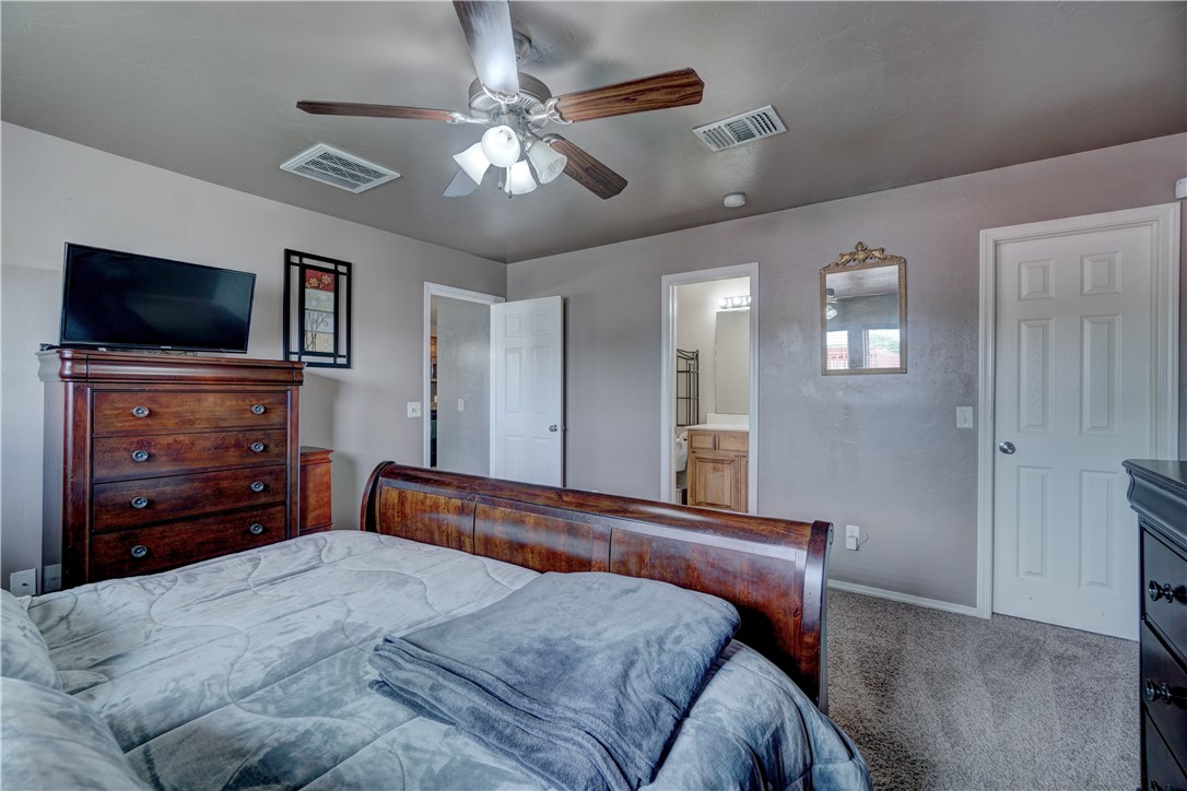 9533 SW 25th Street, Oklahoma City, OK 73128 bedroom featuring a ceiling fan, carpet, and TV