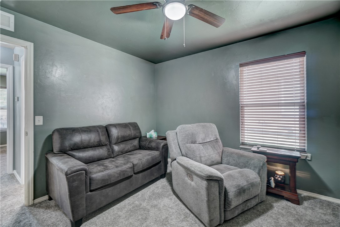 9533 SW 25th Street, Oklahoma City, OK 73128 carpeted living room featuring a ceiling fan and natural light