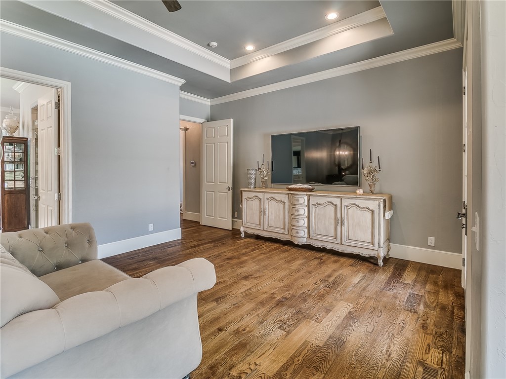4020 NE 117th Street, Oklahoma City, OK 73131 living room with wood-type flooring and TV