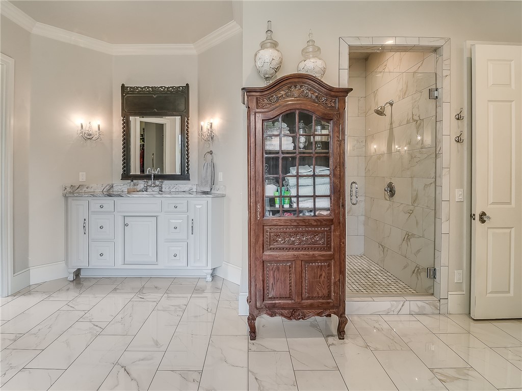 4020 NE 117th Street, Oklahoma City, OK 73131 bathroom featuring tile flooring, double vanity, mirror, and shower booth