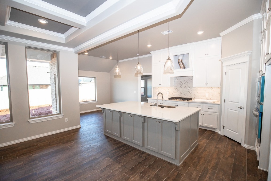 This Hazel Bonus Room 5 Bedroom has 2,735 Sqft of total living space, which includes 2,520 Sqft of indoor living space & 215 Sqft of outdoor living space. Home offers 5 bedrooms, 3 full baths w/ 3 CM countertops/backsplash, 2 covered patios, a large bonus room, & a 3 car garage w/ a storm shelter installed. Living room presents a stacked stone corner gas fireplace, 3 seven ft windows, wood-look tile, & a coffered ceiling. Kitchen supports stainless steel appliances, 3 CM countertops, pendant lighting, a corner pantry, & an oversized island. The primary suite offers a sloped ceiling detail, a ceiling fan, windows, & our cozy carpet finish. Prime bath features a dual sink vanity, a Jetta Whirlpool tub, a walk-in shower, & a HUGE walk-in closet. Outdoor living boasts a wood-burning fireplace, a gas line for your grill, & a TV hookup for your flatscreen. Home also offers our healthy home technology, a tankless water heater, a whole home air purification system, R-44 insulation, & more!