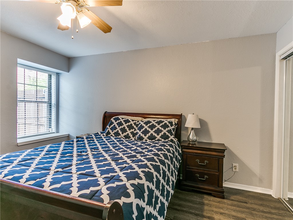 14407 N Pennsylvania Avenue, #12P, Oklahoma City, OK 73134 hardwood floored bedroom with multiple windows and a ceiling fan