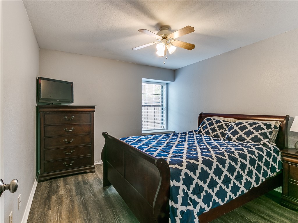 14407 N Pennsylvania Avenue, #12P, Oklahoma City, OK 73134 bedroom featuring wood-type flooring, a ceiling fan, natural light, and TV