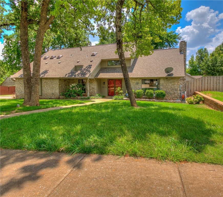 3815 Marked Tree Drive, Edmond, OK 73013 view of front facade with a front lawn