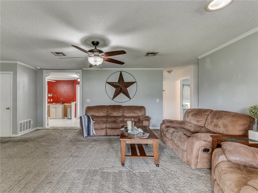 8909 Kenny Circle, Oklahoma City, OK 73132 carpeted living room featuring a ceiling fan