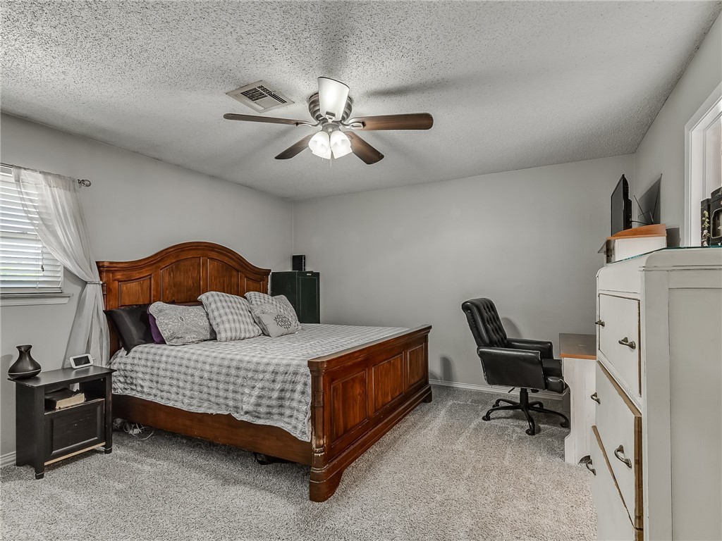 8909 Kenny Circle, Oklahoma City, OK 73132 carpeted bedroom featuring a ceiling fan