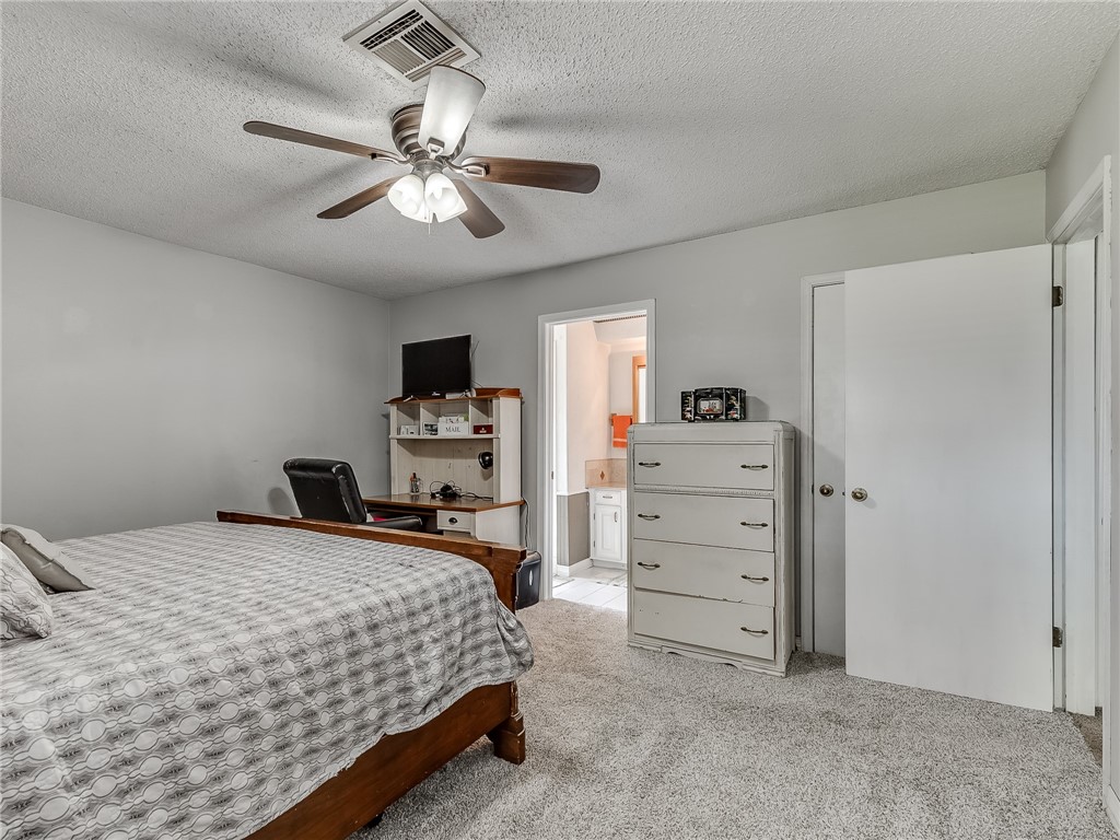 8909 Kenny Circle, Oklahoma City, OK 73132 bedroom with a ceiling fan, carpet, and TV