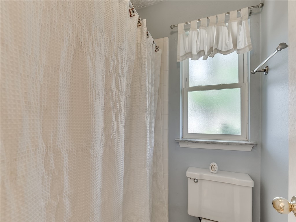8909 Kenny Circle, Oklahoma City, OK 73132 bathroom featuring toilet and shower curtain