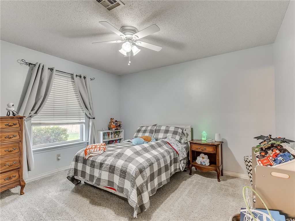 8909 Kenny Circle, Oklahoma City, OK 73132 bedroom with natural light, carpet, and a ceiling fan