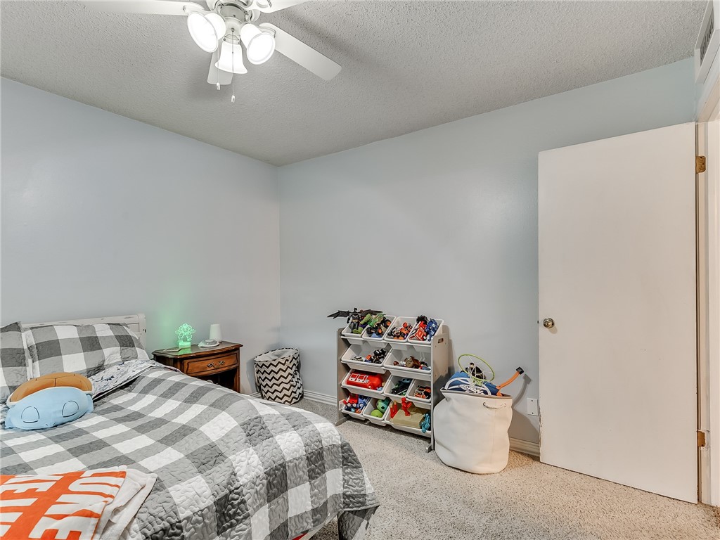 8909 Kenny Circle, Oklahoma City, OK 73132 carpeted bedroom with a ceiling fan