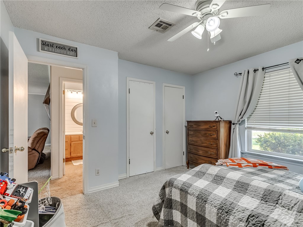 8909 Kenny Circle, Oklahoma City, OK 73132 bedroom featuring a ceiling fan, carpet, and natural light