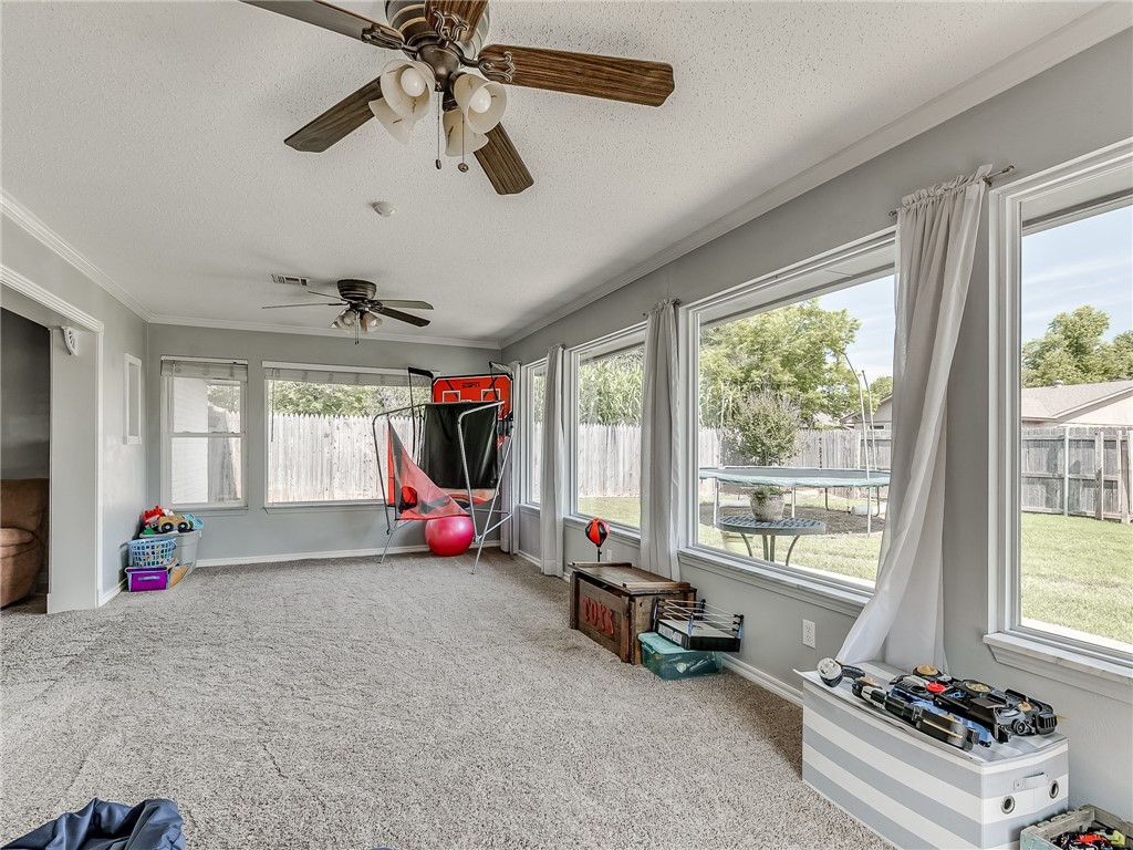 8909 Kenny Circle, Oklahoma City, OK 73132 playroom with a ceiling fan, carpet, and natural light
