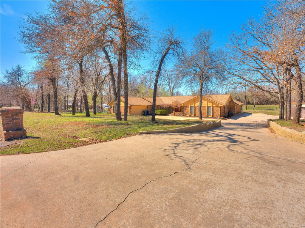 This wooded, nature-lover’s paradise is located just 1.5 miles from Tinker AFB with 5 bedrooms and 2.5 bathrooms, and features a 3-car shop + 2-car garage, a pool, and an incredible view of wildlife in the pasture beyond the creek. The concrete pool was repainted (2017), with new pump (2019), filter and cover (2022). The enormous interior features a kitchen with marble and quartz counters along with updated hickory oak cabinets and double oven, a living room with a triple-tray ceiling and a large bay window, a family room with a vaulted ceiling along with built in cabinets and fireplace, and a spacious master suite with walk in shower and access straight to the pool. Other features include wood flooring in formal dining, large pantry, half bath off the office/5th bed, and a huge driveway with RV sewer and electric hookups. The list goes on and on. Ask your realtor for the whole list of updates, including 2 new HVAC systems in 2021 and 2022. Come enjoy this view while it lasts!