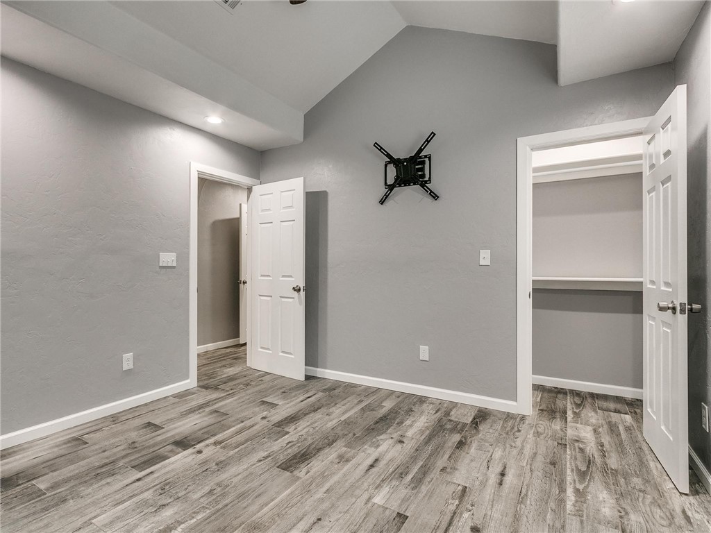 2115 N Jordan Avenue, Oklahoma City, OK 73111 hardwood floored bedroom with vaulted ceiling