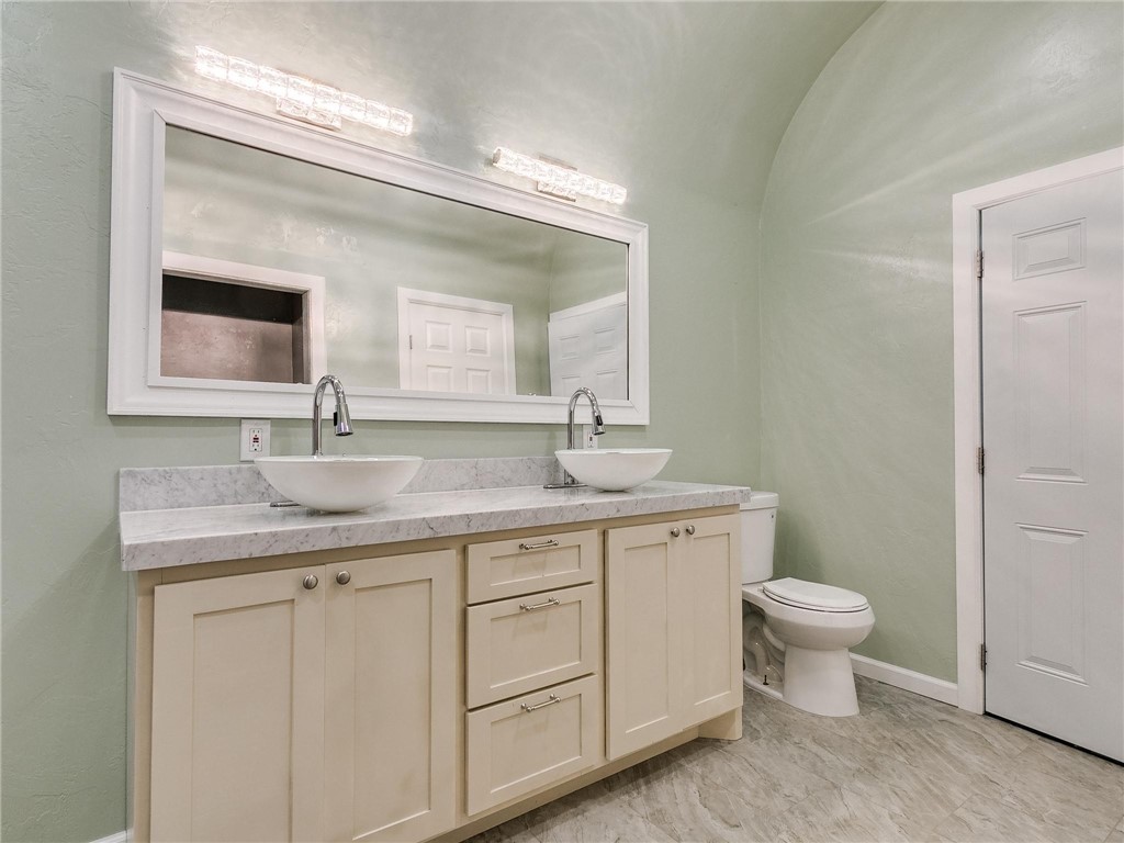 2115 N Jordan Avenue, Oklahoma City, OK 73111 half bath with toilet, mirror, and double vanity