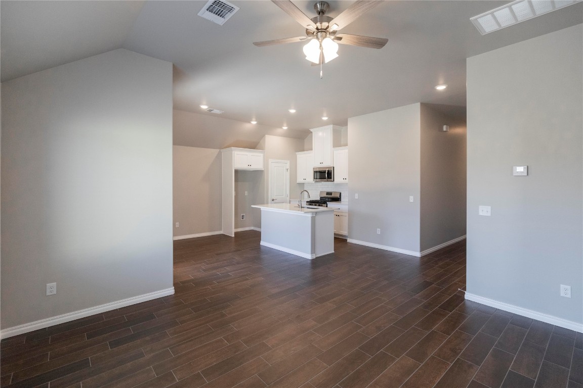 This John floor plan includes 1,310 Sqft of total living space, which includes 1,200 Sqft of indoor living space & 110 Sqft of outdoor living space. There is also a 385 Sqft, two car garage w/ a storm shelter installed. Home offers 3 beds, 2 baths, 2 covered patios, & a utility room! Living room includes high ceilings, exquisite wood-look tile, a ceiling fan, & the perfect sized windows. Kitchen holds cabinets w/ decorative hardware, Frigidaire stainless-steel appliances, decorative tile backsplash, elegant countertops, & wood-look tile. Primary suite features 2 windows, a ceiling fan, our cozy carpet finish, & a sizeable walk-in closet. Attached is the primary bath which holds a dual sink vanity complimented by a 3 CM quartz countertop, satin nickel features, & a walk-in shower w/ tile to the ceiling. Outdoor living includes fully sodded yards, a smart home irrigation system, & 30-yr weather wood shingles. Other amenities include a water-saving tankless water heater, a fresh air intake system, R-15 & R-38 insulation, & more!