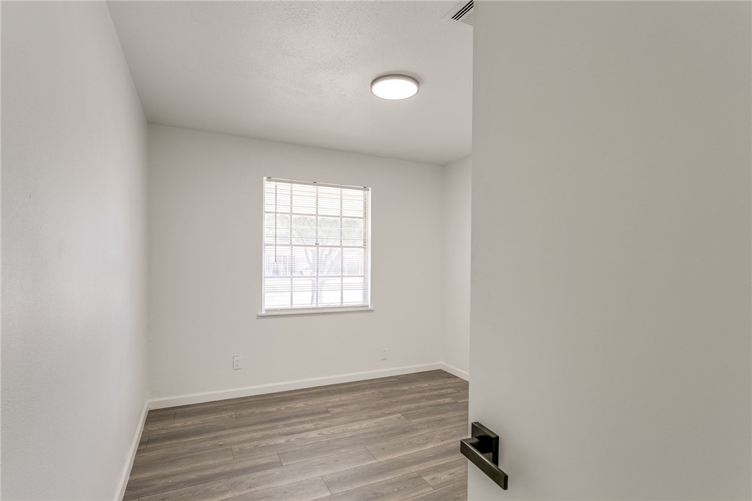 3029 S Madole Boulevard, Oklahoma City, OK 73159 wood floored empty room featuring natural light